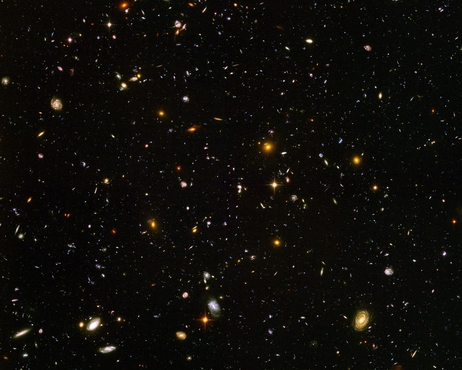 Deep field view showing thousands of galaxies in a tiny patch of sky