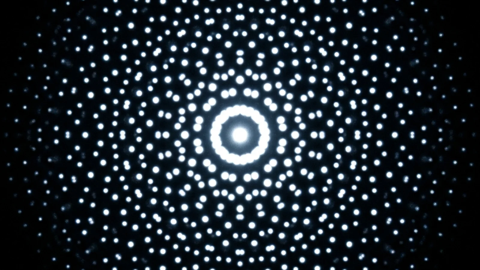 Electron diffraction pattern of an icosahedral quasicrystal showing 10-fold rotational symmetry - sharp bright dots arranged in concentric decagonal rings, a pattern impossible in any periodic crystal