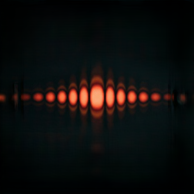 Laser light diffraction pattern showing concentric bright and dark rings radiating from central bright spot